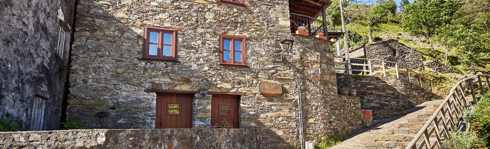 The schist façade of Casa das Bugalhas in the sunshine, in Candal