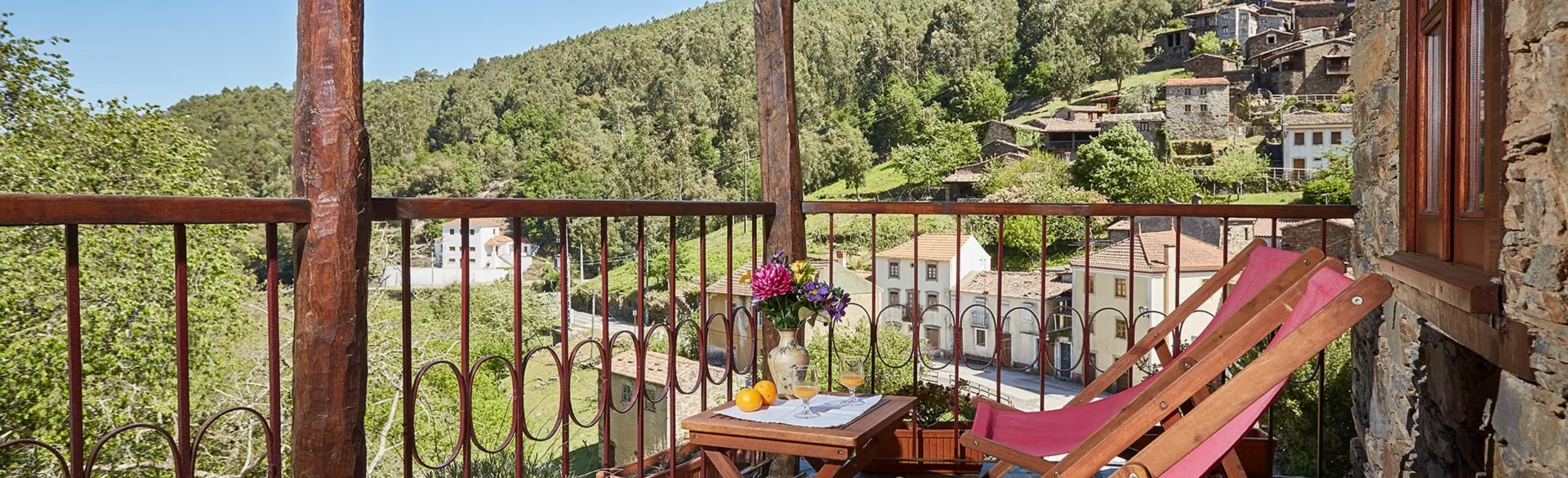 Balcony looking out over the wooded hillside and the schist houses of Candal
