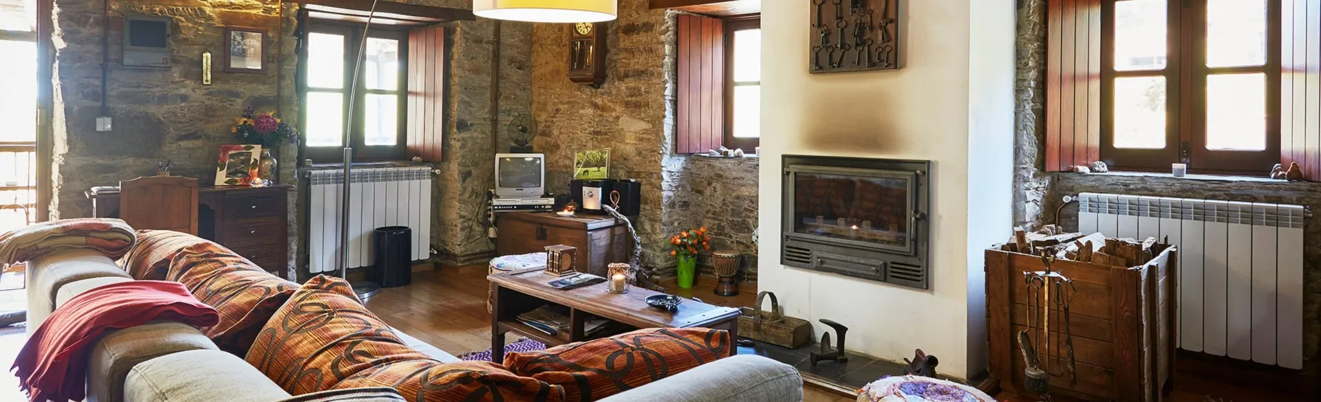 Living room with a wood-burning stove and wood-fired central heating