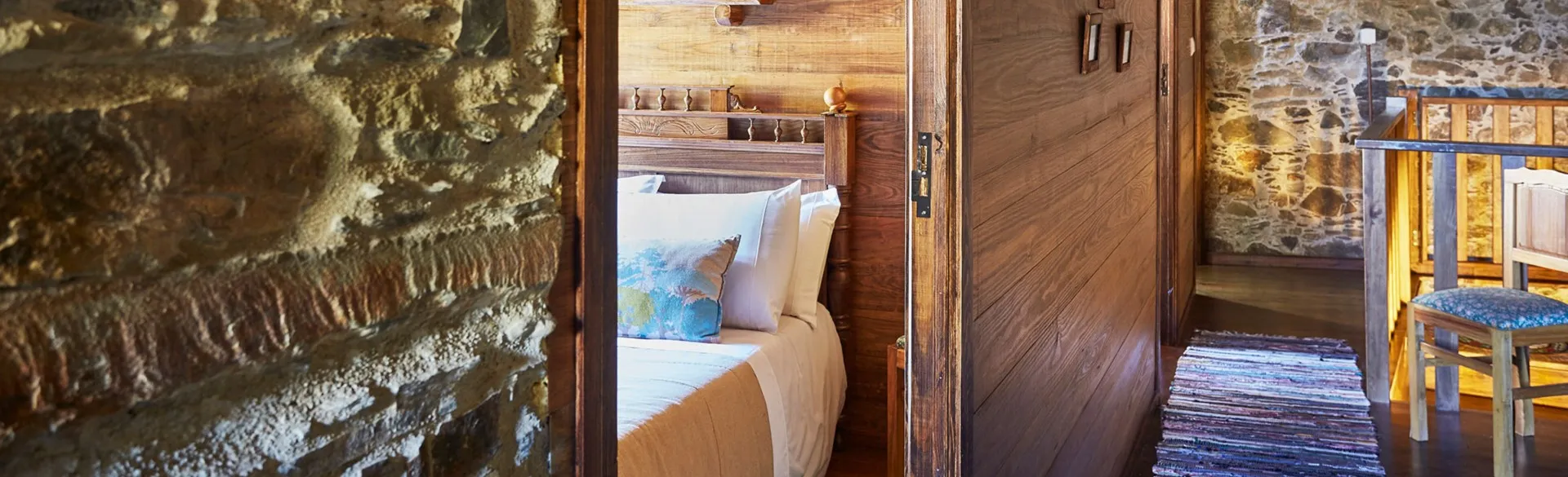 Interior hallway in schist and timber, leading to the bedrooms