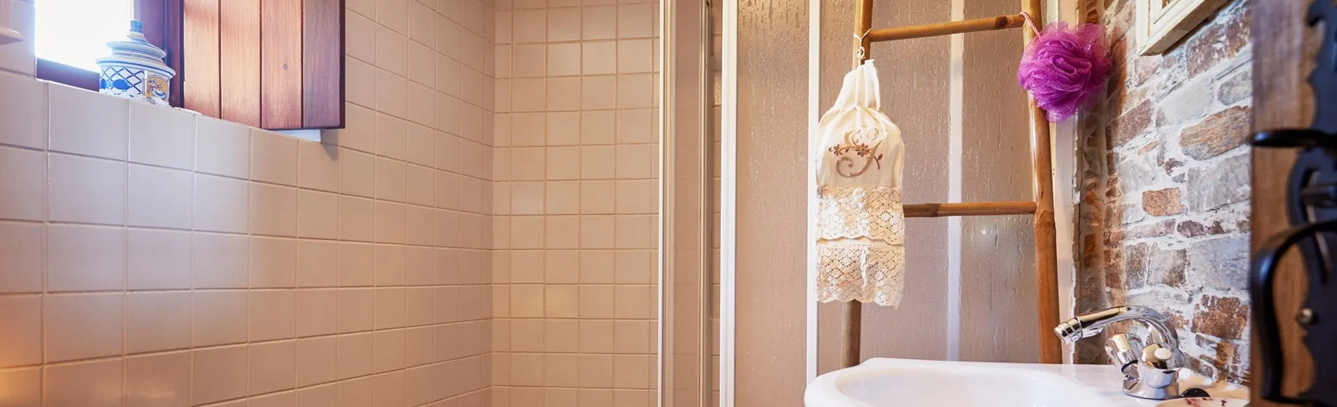 Bathroom with a bathtub and exposed stone wall